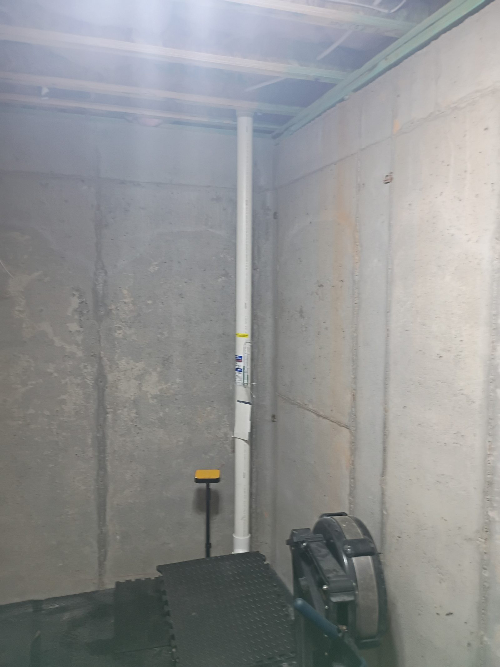 Unfinished basement with a radon riser